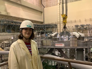 Ella stood by a JT60-SA tokamak